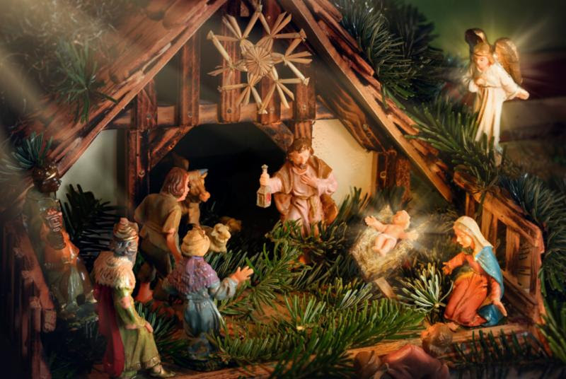 Christmas nativity statue scene with Jesus in a manger and an Angel.